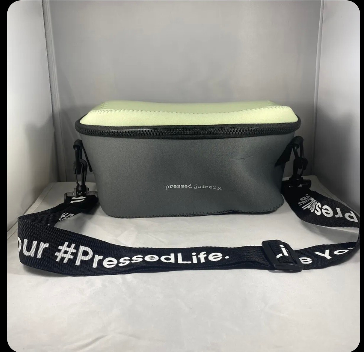 Pressed Juicery neoprene fanny pack / waist bag in mint-black color. Insulated.