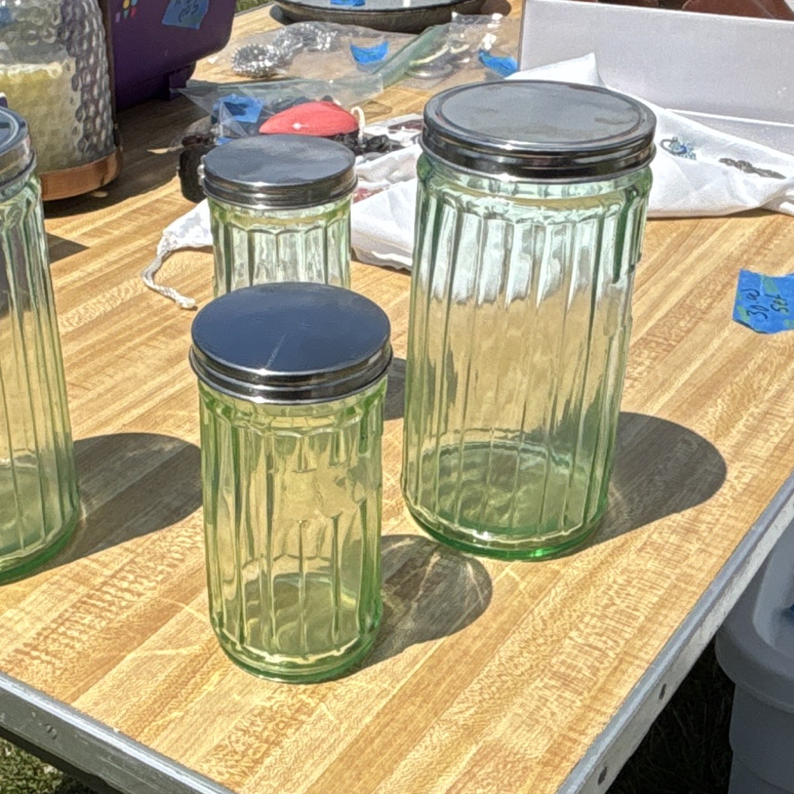 Vintage green glass ribbed storage containers with tin lids-