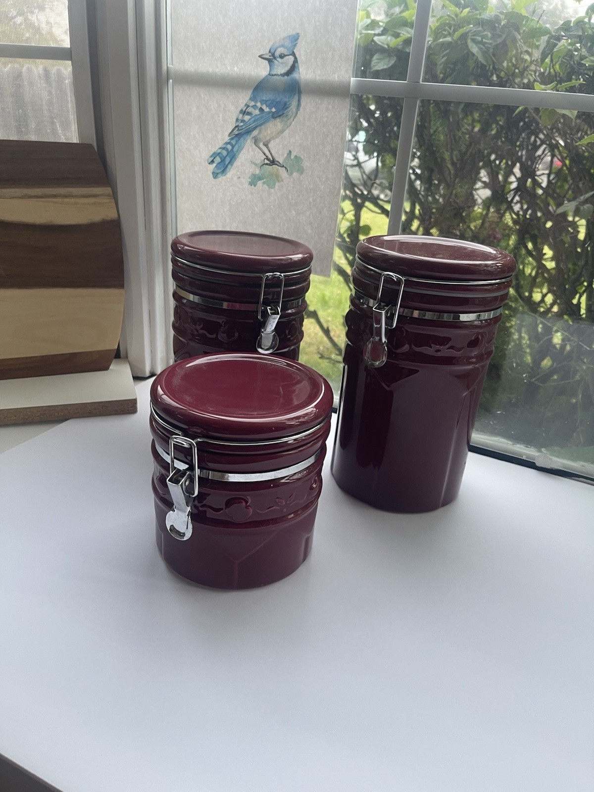 Three Maroon Ceramic Canisters with Lids